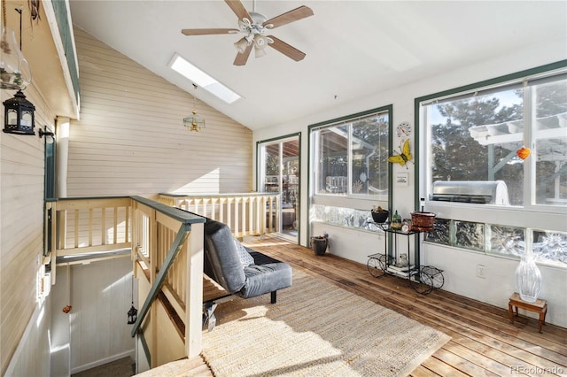 sunroom / solarium featuring ceiling fan, lofted ceiling with skylight, and a healthy amount of sunlight