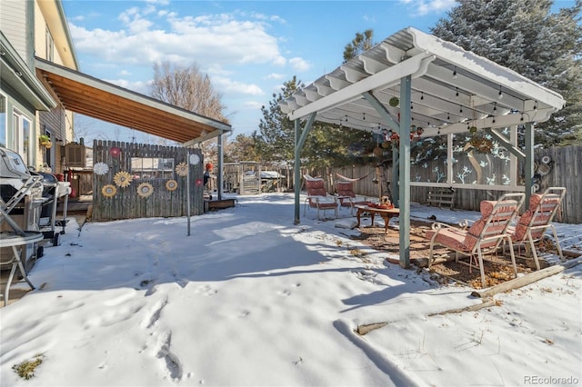 snowy yard featuring a pergola