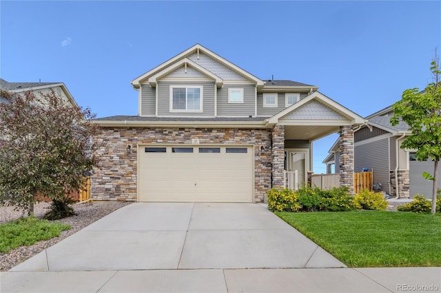 craftsman house featuring driveway, stone siding, a garage, and a front lawn