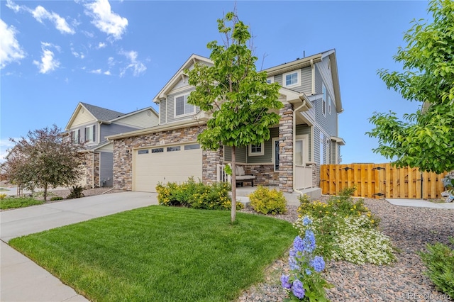 view of front of house featuring driveway, a garage, stone siding, fence, and a front lawn