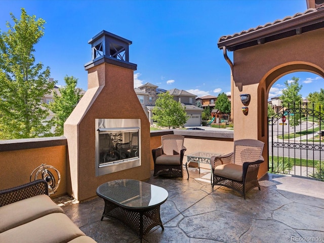 2256 S Isabell Ct, Lakewood, CO 80228 - view of patio featuring a multi sided fireplace and a residential view