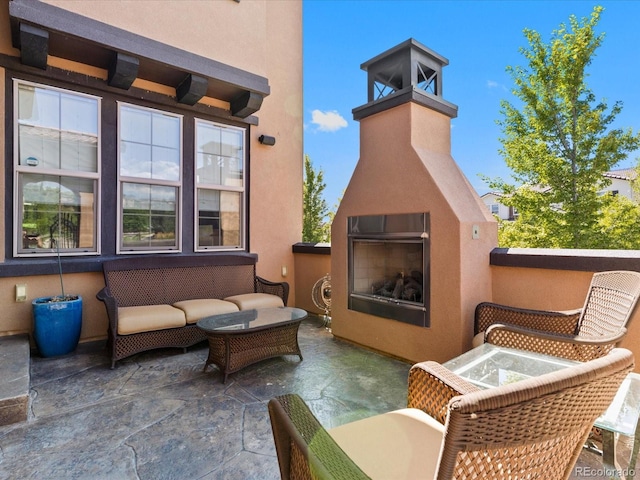 2256 S Isabell Ct, Lakewood, CO 80228 - view of patio featuring a glass covered fireplace