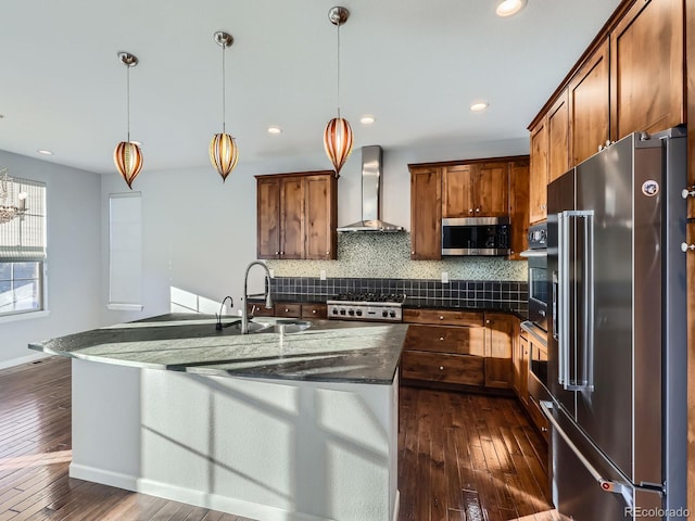 2256 S Isabell Ct, Lakewood, CO 80228 - kitchen featuring appliances with stainless steel finishes, wall chimney range hood, a sink, dark countertops, and dark wood finished floors