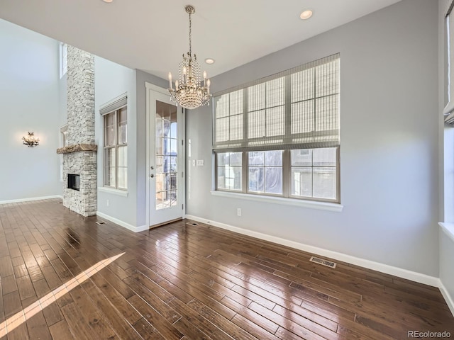 2256 S Isabell Ct, Lakewood, CO 80228 - unfurnished dining area with a chandelier, wood-type flooring, a fireplace, baseboards, and recessed lighting
