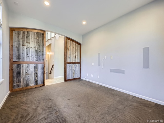 2256 S Isabell Ct, Lakewood, CO 80228 - carpeted empty room with arched walkways, baseboards, and recessed lighting