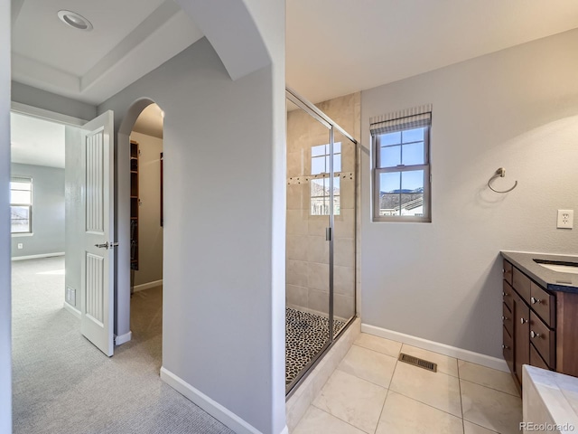 2256 S Isabell Ct, Lakewood, CO 80228 - bathroom with a shower stall, healthy amount of natural light, and baseboards