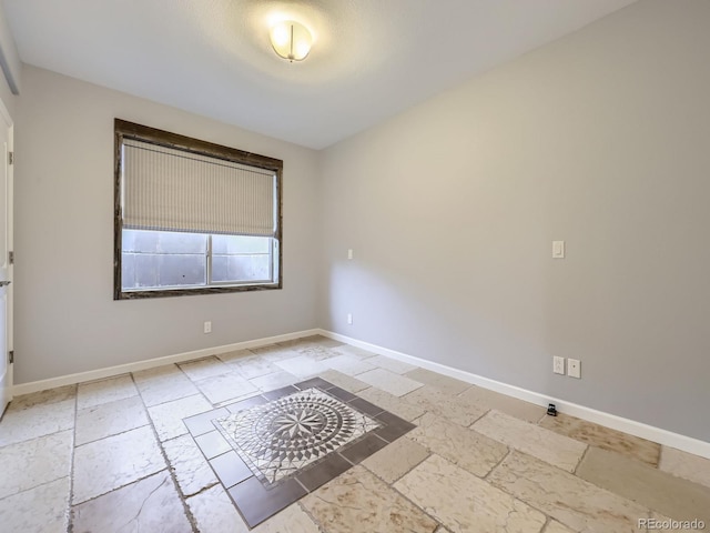 2256 S Isabell Ct, Lakewood, CO 80228 - empty room with stone tile flooring and baseboards