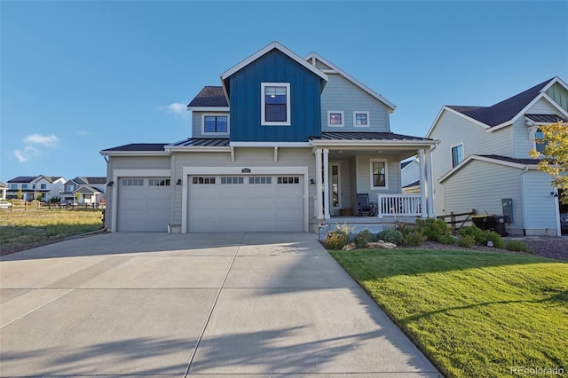 view of front facade with a front yard, a porch, and a garage