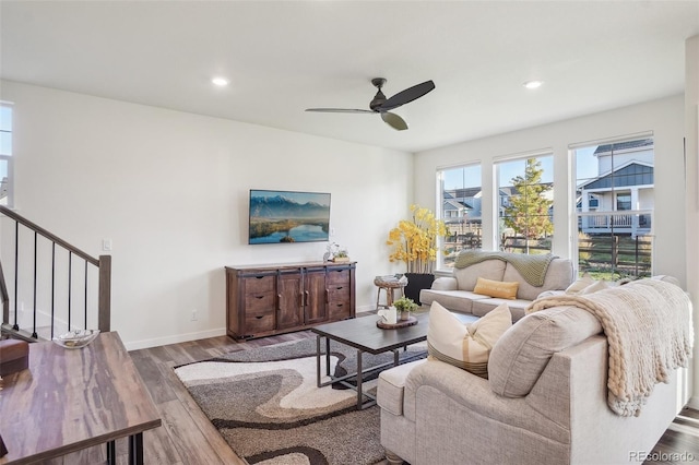 living room featuring ceiling fan and wood-type flooring