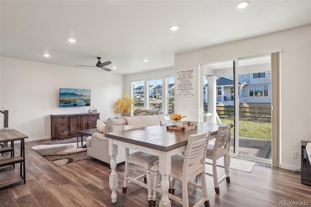 dining room with hardwood / wood-style flooring and ceiling fan