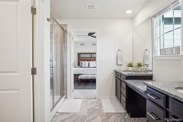 bathroom featuring ceiling fan, an enclosed shower, and vanity