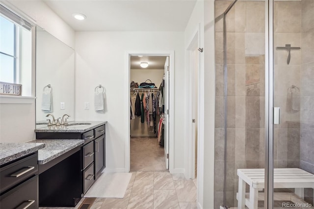 bathroom featuring vanity and a shower with shower door