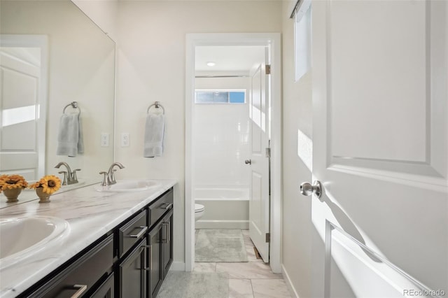 full bathroom featuring shower / bathing tub combination, vanity, and toilet