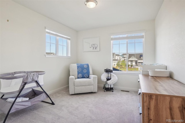 sitting room featuring light colored carpet