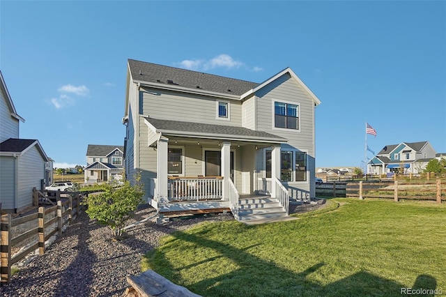 back of house with a lawn and a porch