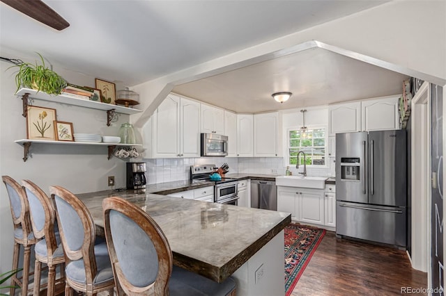 134 S 5th Ave, Brighton, CO 80601 - kitchen featuring stainless steel appliances, a sink, a peninsula, and white cabinets