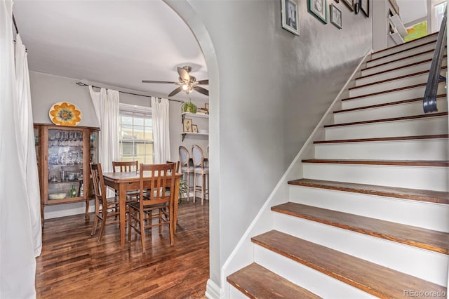 134 S 5th Ave, Brighton, CO 80601 - stairway with wood finished floors, a ceiling fan, arched walkways, and baseboards