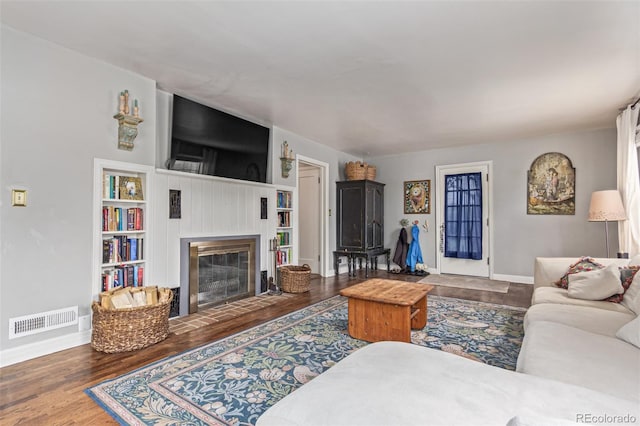 134 S 5th Ave, Brighton, CO 80601 - living room with baseboards, wood finished floors, and a fireplace with flush hearth