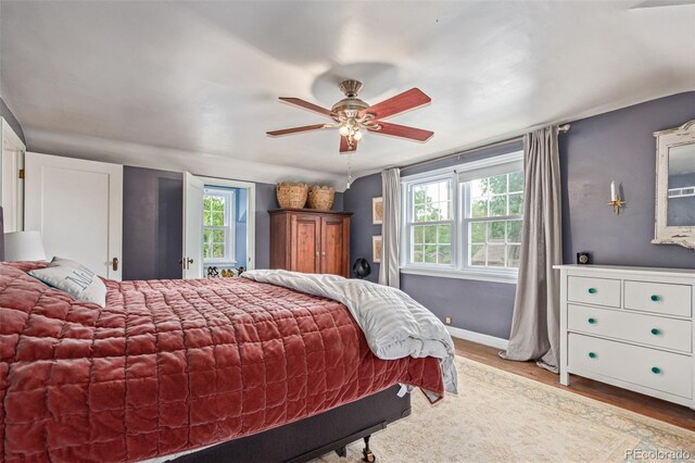 134 S 5th Ave, Brighton, CO 80601 - bedroom featuring wood finished floors, baseboards, and a ceiling fan