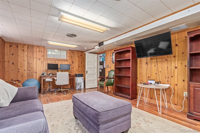134 S 5th Ave, Brighton, CO 80601 - living area with wooden walls, wood finished floors, and a desk