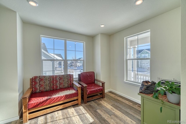 living area with hardwood / wood-style floors and a textured ceiling