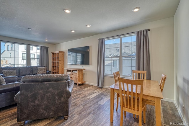 living room with a textured ceiling and dark hardwood / wood-style floors