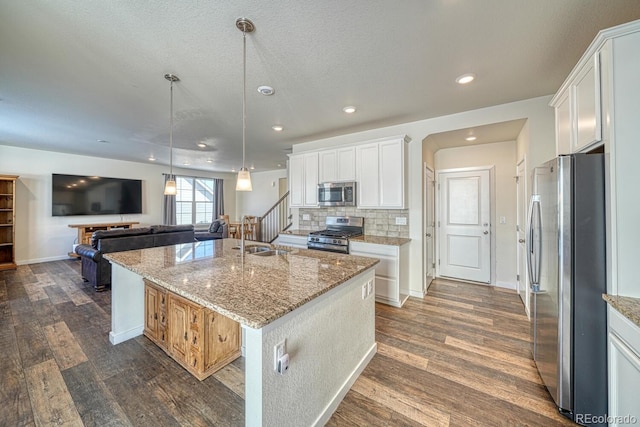 kitchen featuring white cabinetry, an island with sink, appliances with stainless steel finishes, and sink