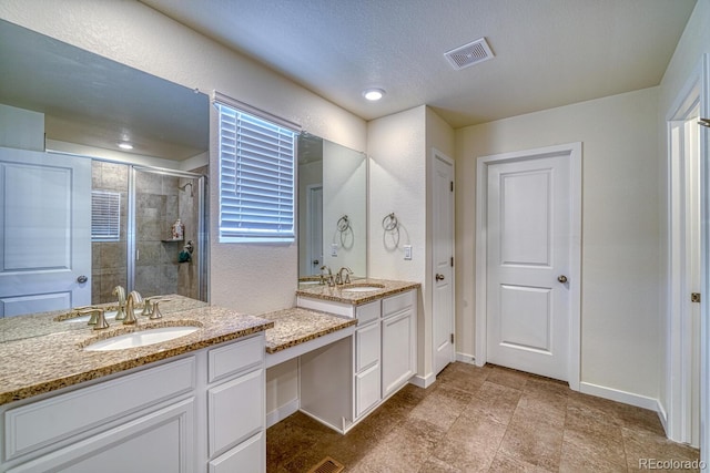 bathroom featuring vanity and a shower with shower door