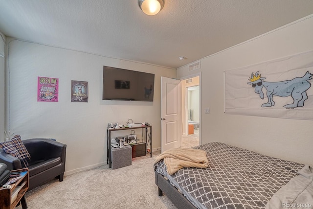 bedroom featuring carpet floors and a textured ceiling