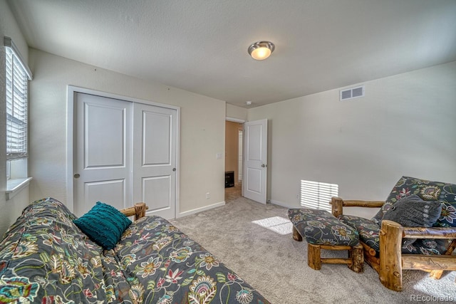 bedroom featuring light carpet and a closet