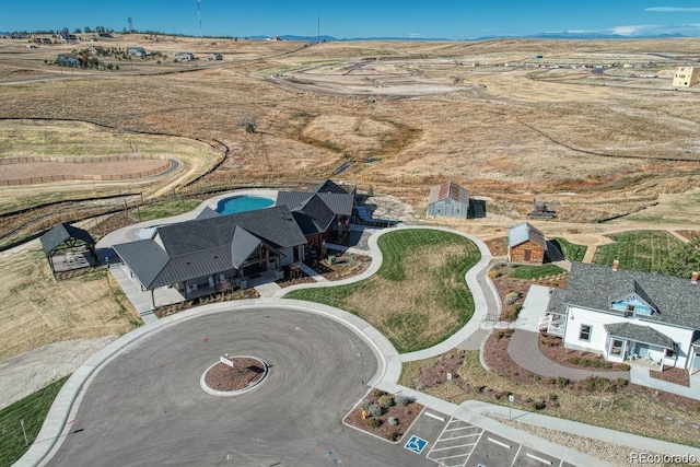 birds eye view of property with a rural view