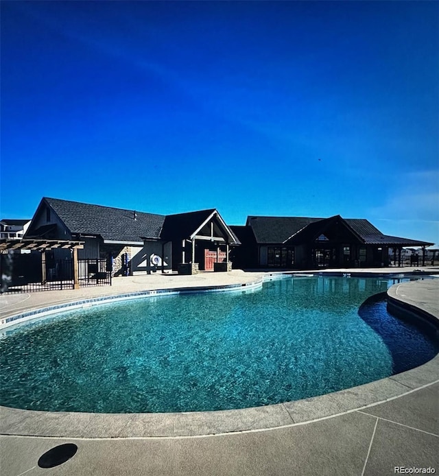 view of pool with a pergola and a patio