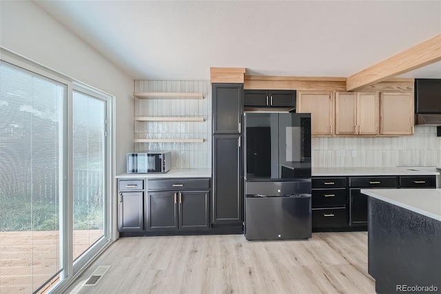 kitchen with backsplash, stainless steel fridge, light hardwood / wood-style floors, and light brown cabinets