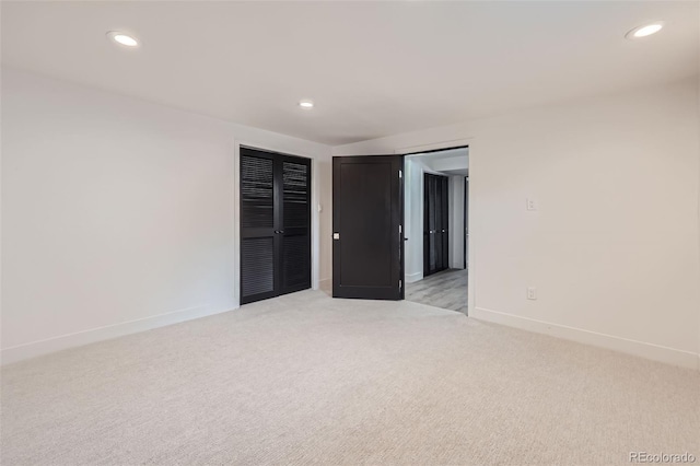 unfurnished room with light carpet