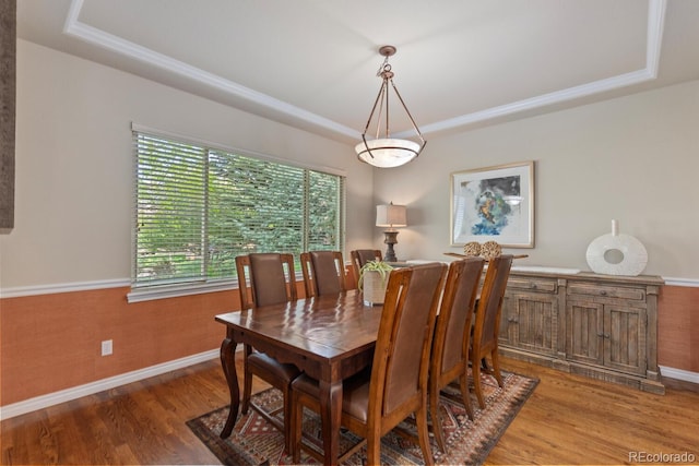 6874 Raspberry Run, Littleton, CO 80125 - dining room featuring a raised ceiling, wood finished floors, and baseboards
