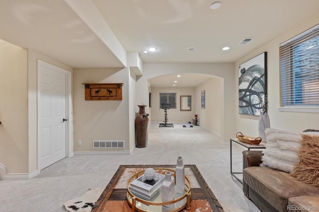 6874 Raspberry Run, Littleton, CO 80125 - living area with arched walkways, carpet flooring, baseboards, and recessed lighting