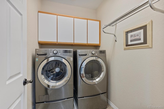 6874 Raspberry Run, Littleton, CO 80125 - laundry area with cabinet space, washer and dryer, and baseboards
