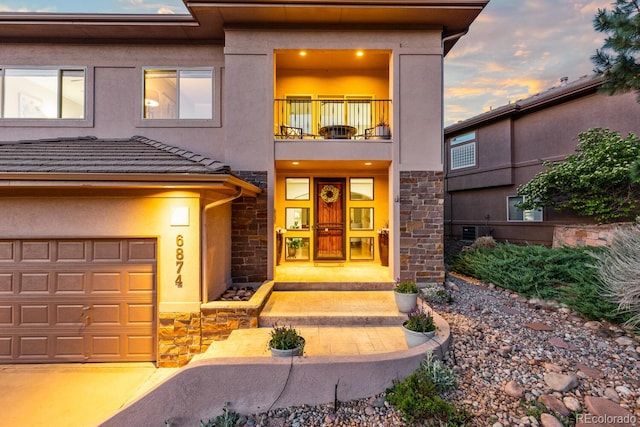 6874 Raspberry Run, Littleton, CO 80125 - view of front of property with stone siding, a balcony, and stucco siding