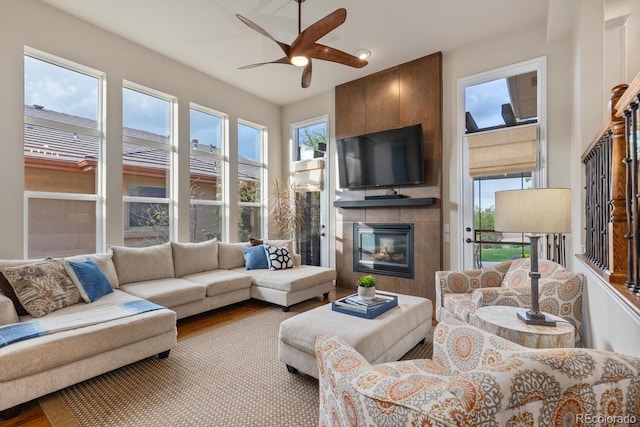 6874 Raspberry Run, Littleton, CO 80125 - living area featuring a ceiling fan, a fireplace, and wood finished floors