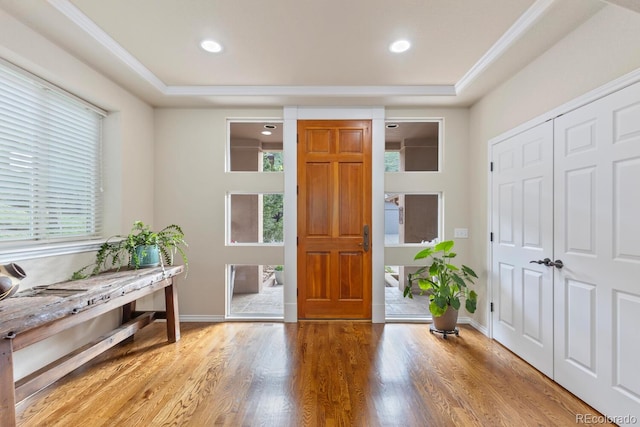 6874 Raspberry Run, Littleton, CO 80125 - foyer entrance featuring light wood-style flooring, baseboards, recessed lighting, a raised ceiling, and crown molding