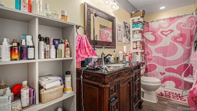 22778 E Alamo Ln, Aurora, CO 80015 - full bath featuring wood finished floors, vanity, and curtained shower