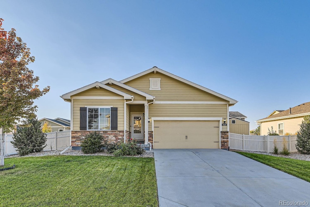 view of front facade with a front yard and a garage