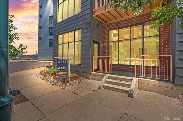 3100 Huron St Unit 1A, Denver, CO 80202 - exterior entry at dusk featuring brick siding