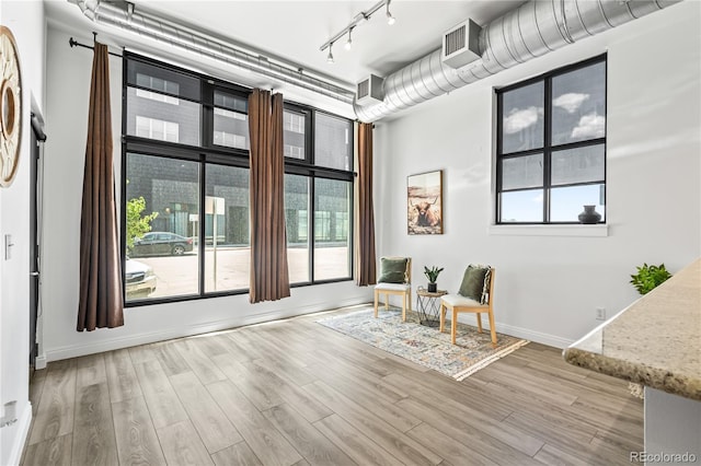 3100 Huron St Unit 1A, Denver, CO 80202 - sitting room with wood finished floors, track lighting, and plenty of natural light