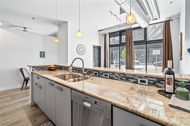 3100 Huron St Unit 1A, Denver, CO 80202 - kitchen featuring dishwasher, gray cabinets, light wood-type flooring, light stone countertops, and track lighting