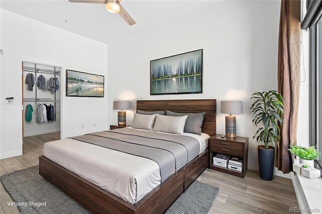 3100 Huron St Unit 1A, Denver, CO 80202 - bedroom featuring light wood-type flooring, a ceiling fan, and a spacious closet