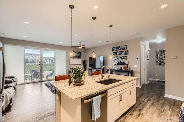 10555 Boston St, Commerce City, CO 80640 - kitchen featuring stainless steel dishwasher, a sink, a kitchen island with sink, wood finished floors, and white cabinets