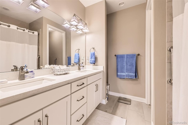10555 Boston St, Commerce City, CO 80640 - bathroom featuring double vanity, tile patterned floors, baseboards, and curtained shower