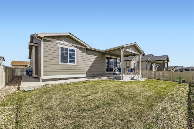 10555 Boston St, Commerce City, CO 80640 - back of house with board and batten siding and a patio