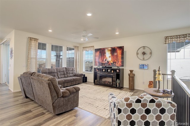 living room with baseboards, a ceiling fan, wood finished floors, a fireplace, and recessed lighting